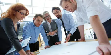 Business team collaborating on a project around a table.